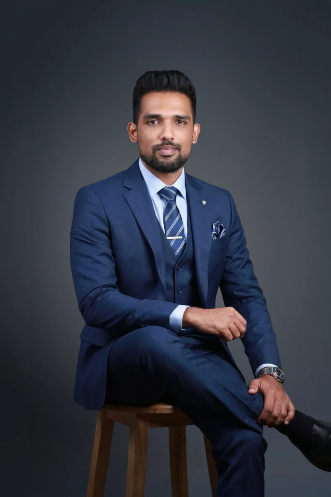 Abdulla Shajahan seated in a navy suit